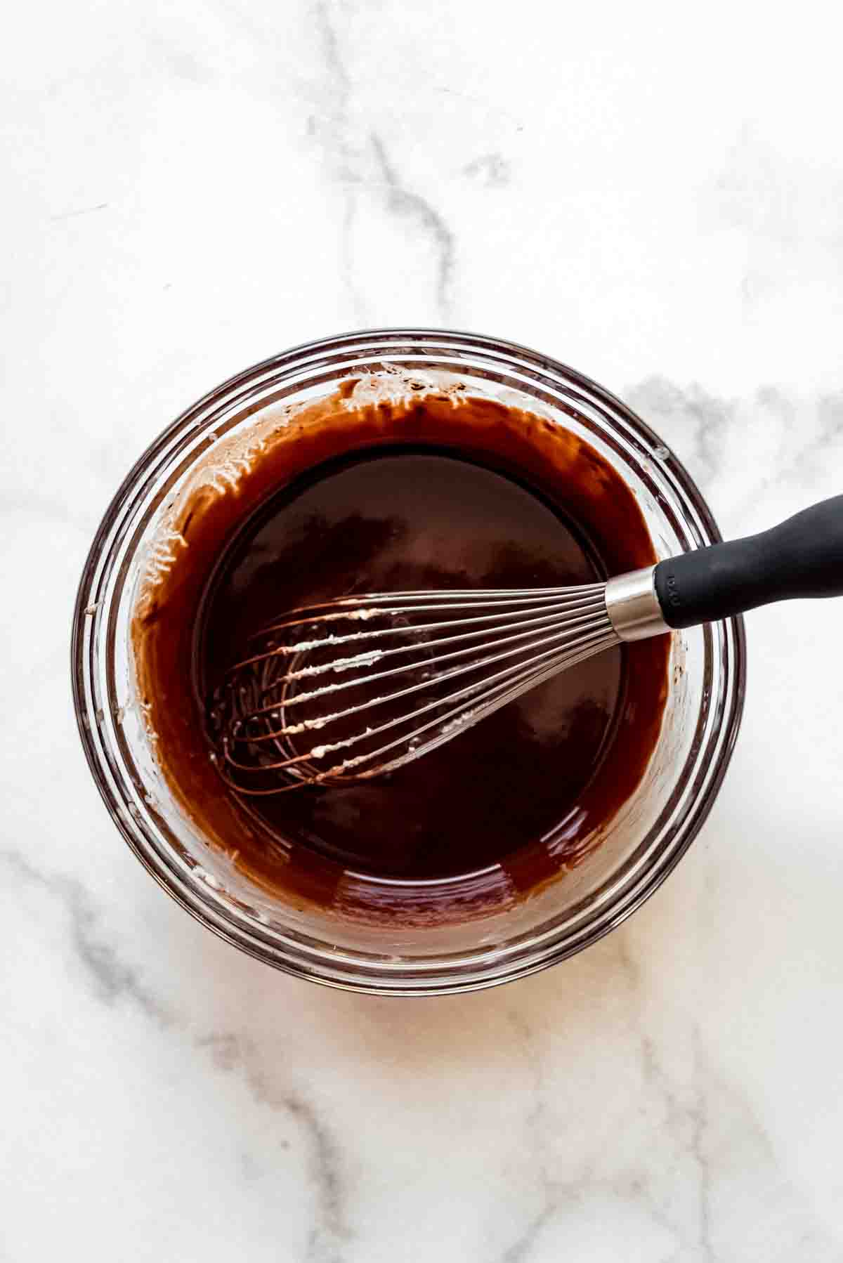 Whisking the chocolate mixture until smooth.