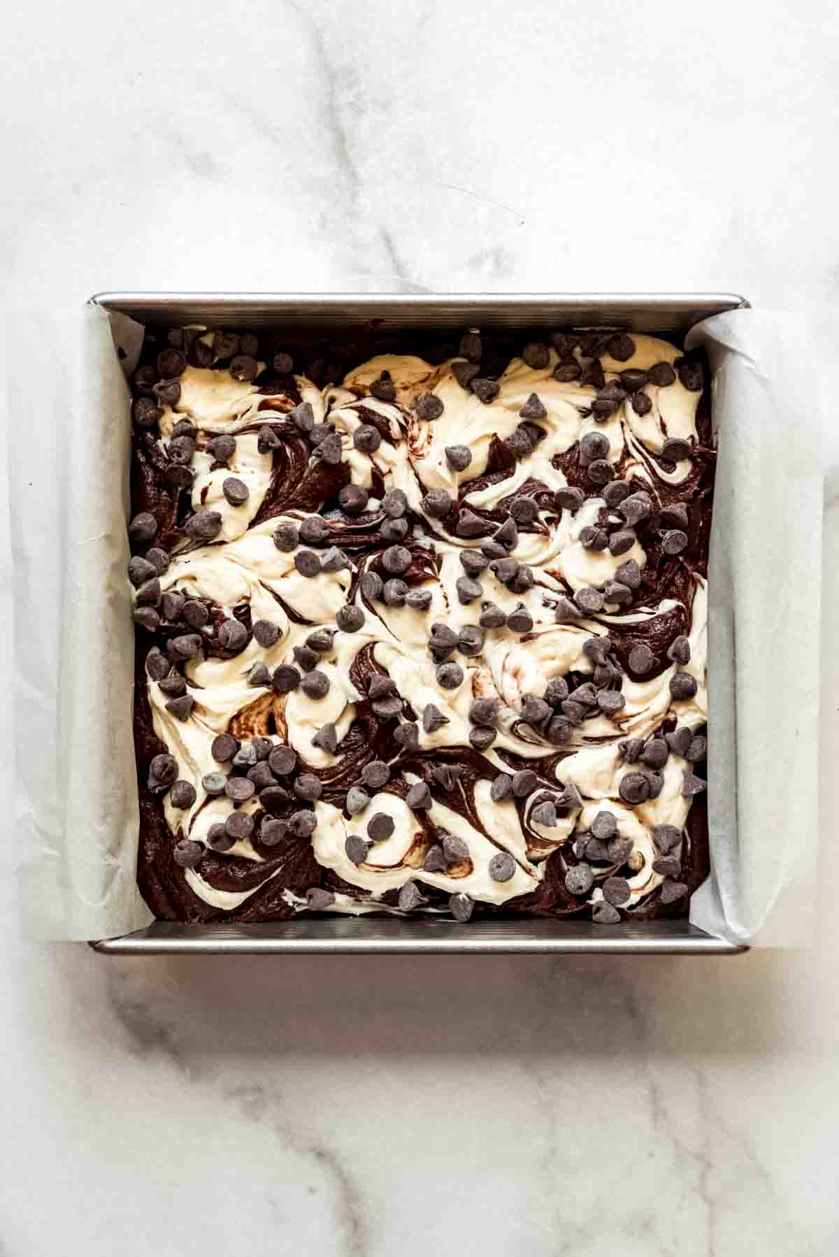 Swirled cream cheese brownies topped with chocolate chips.