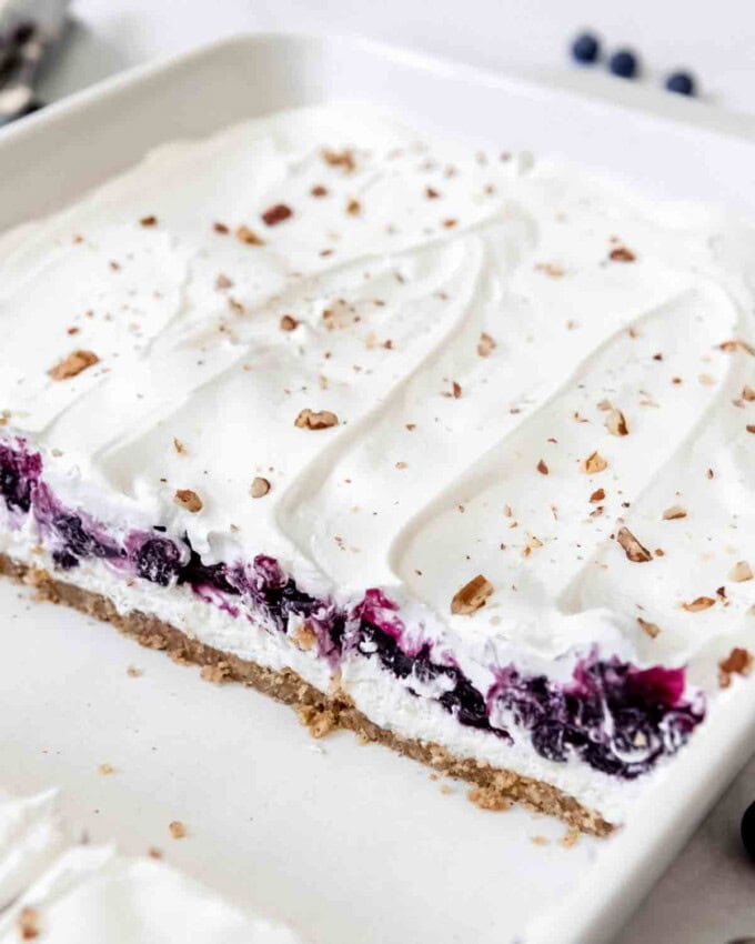 A cross-section showcasing layers of blueberry filling and no-bake cream cheese filling in blueberry delight.