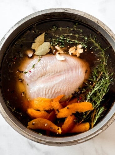 An overhead image of turkey brining in a pot.