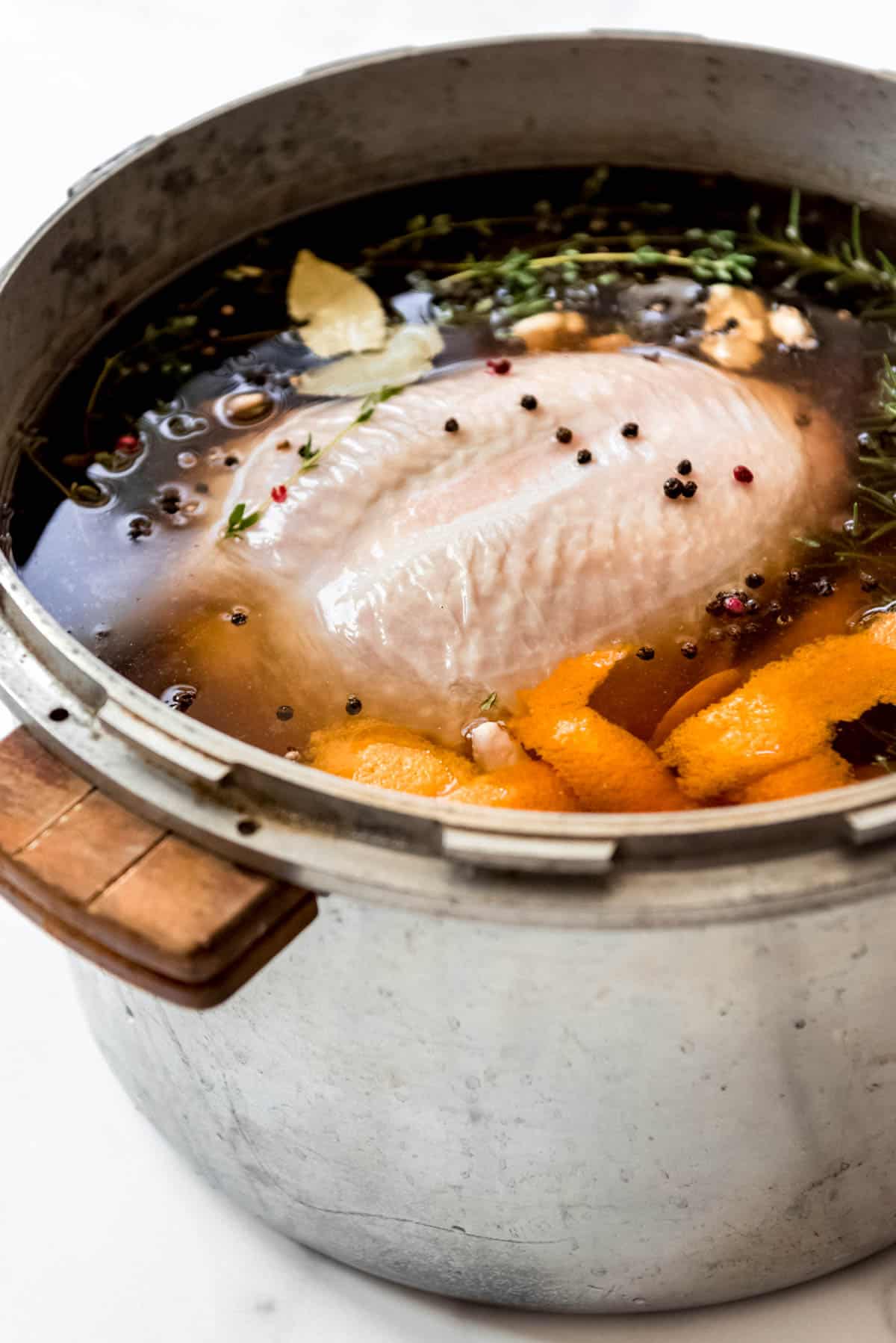 A turkey in brine in a large pot.