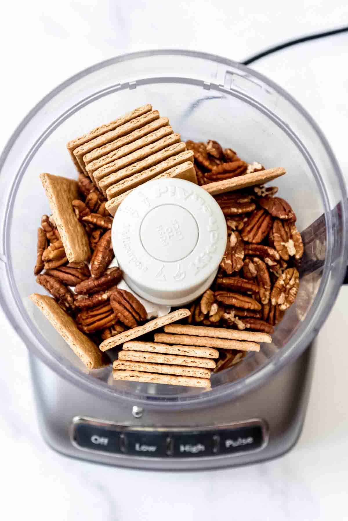 graham crackers and whole pecans in a food processor