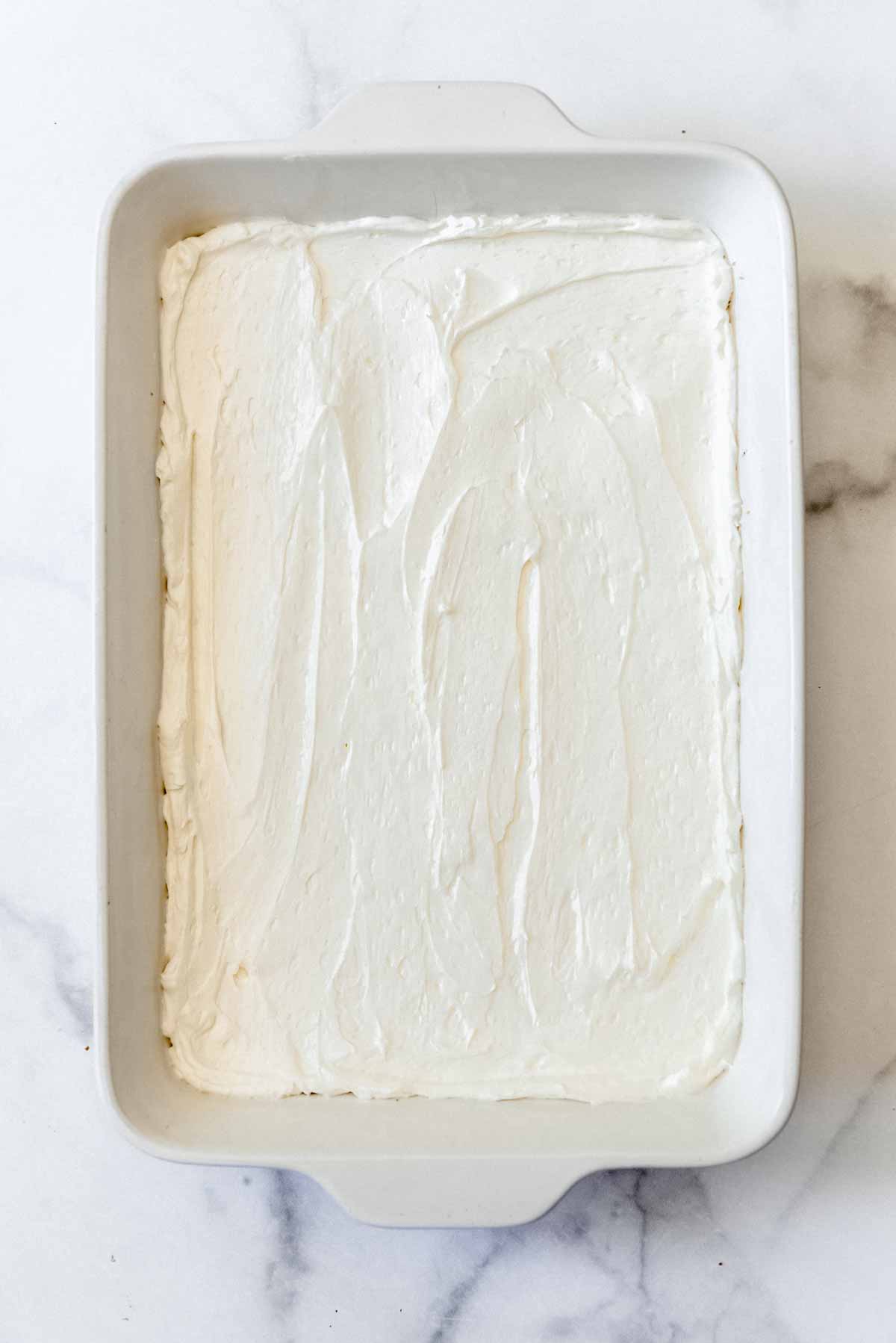 cream mixture spread out over the crust in a baking dish