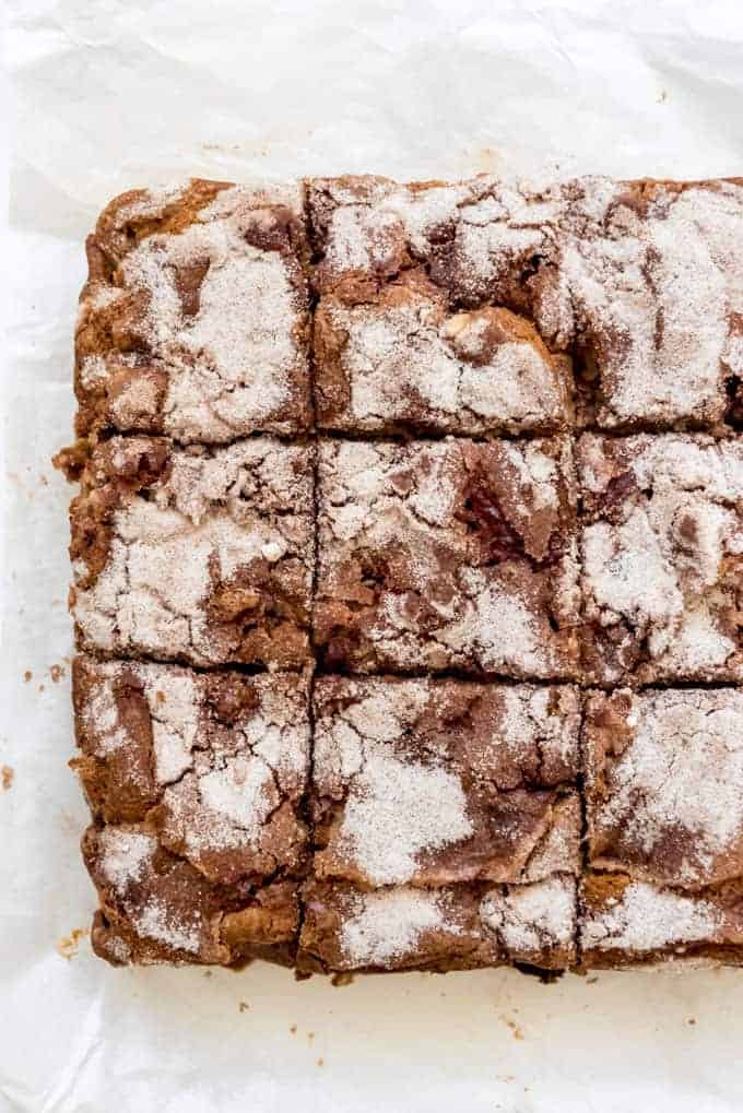 a cake topped with cinnamon sugar and cut into squares