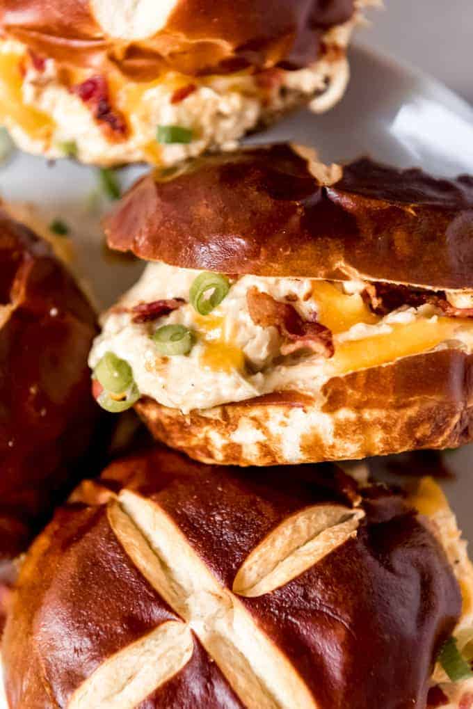 Creamy shredded chicken sandwiches on pretzel buns.