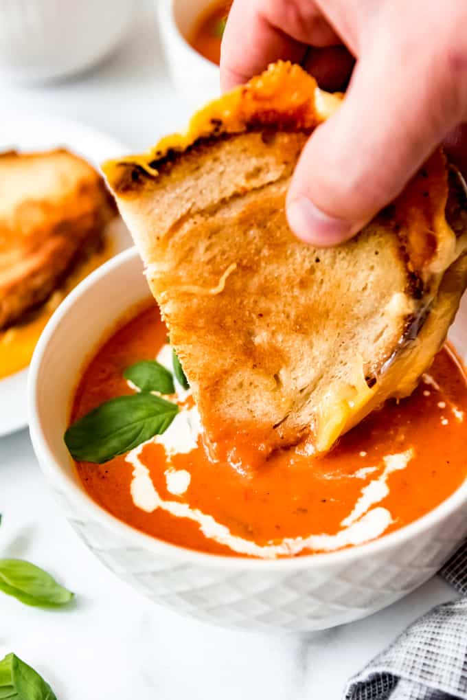 Grilled cheese dipped into tomato soup