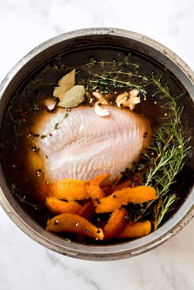 An overhead image of turkey brining in a pot.