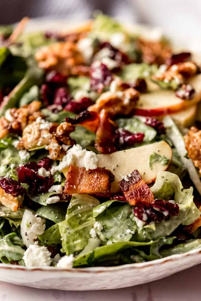Pieces of crisp bacon and feta cheese on a fall apple salad.