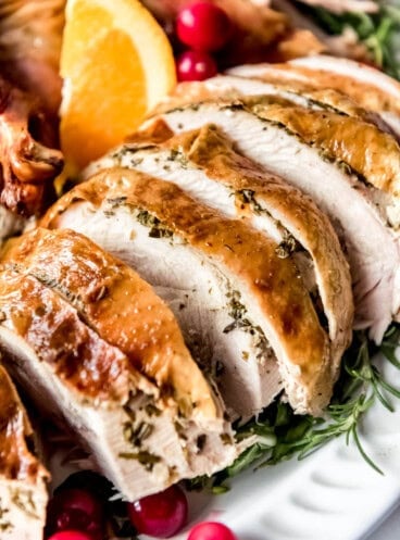 Thick slices of roast turkey breast on a platter.