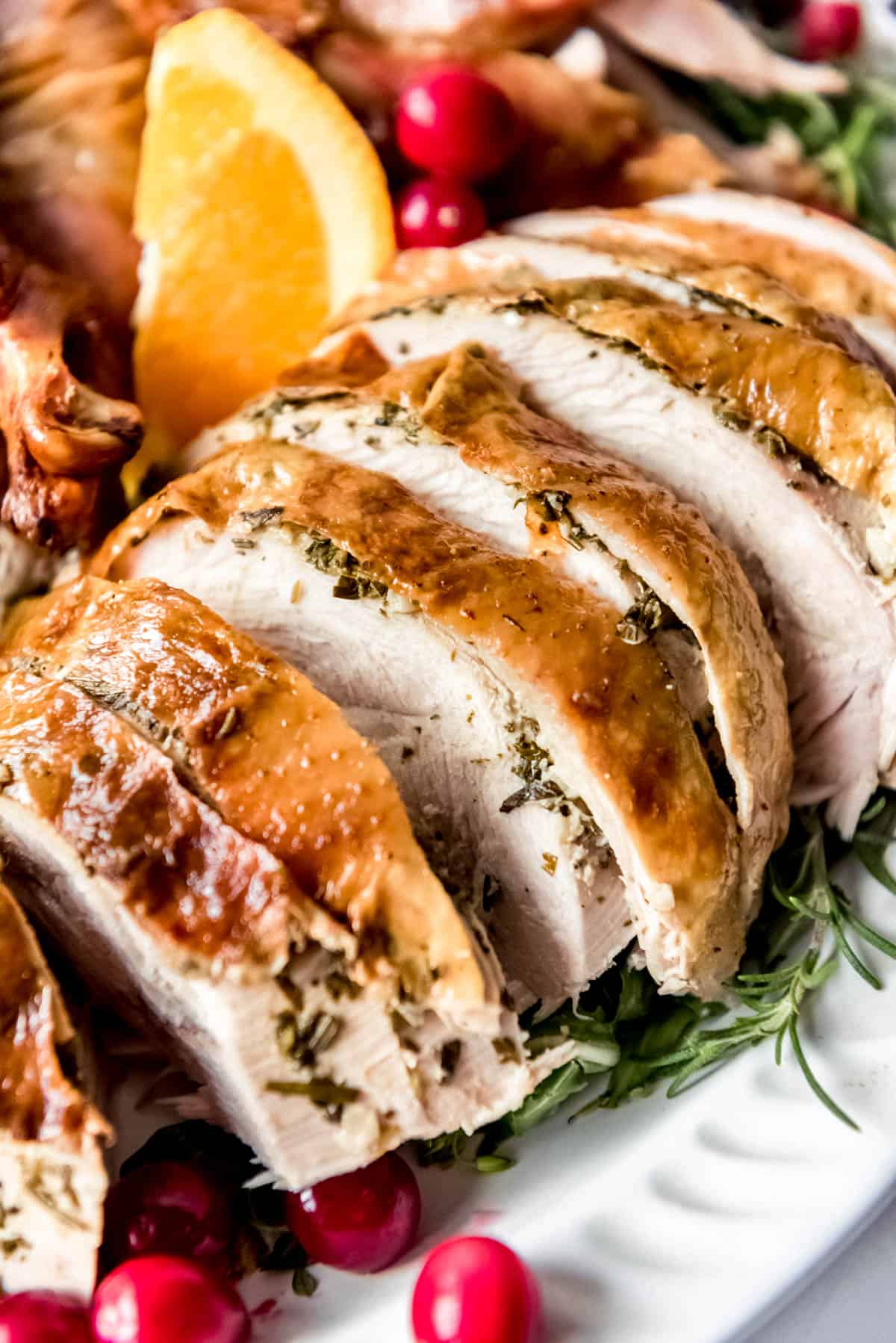 Thick slices of roast turkey breast on a platter.