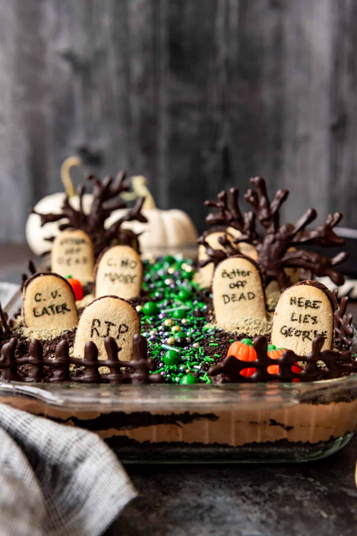 Chocolate dirt pudding with Halloween candy and cookie tombstones on top.