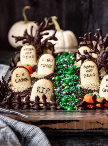 Chocolate dirt pudding with Halloween candy and cookie tombstones on top.