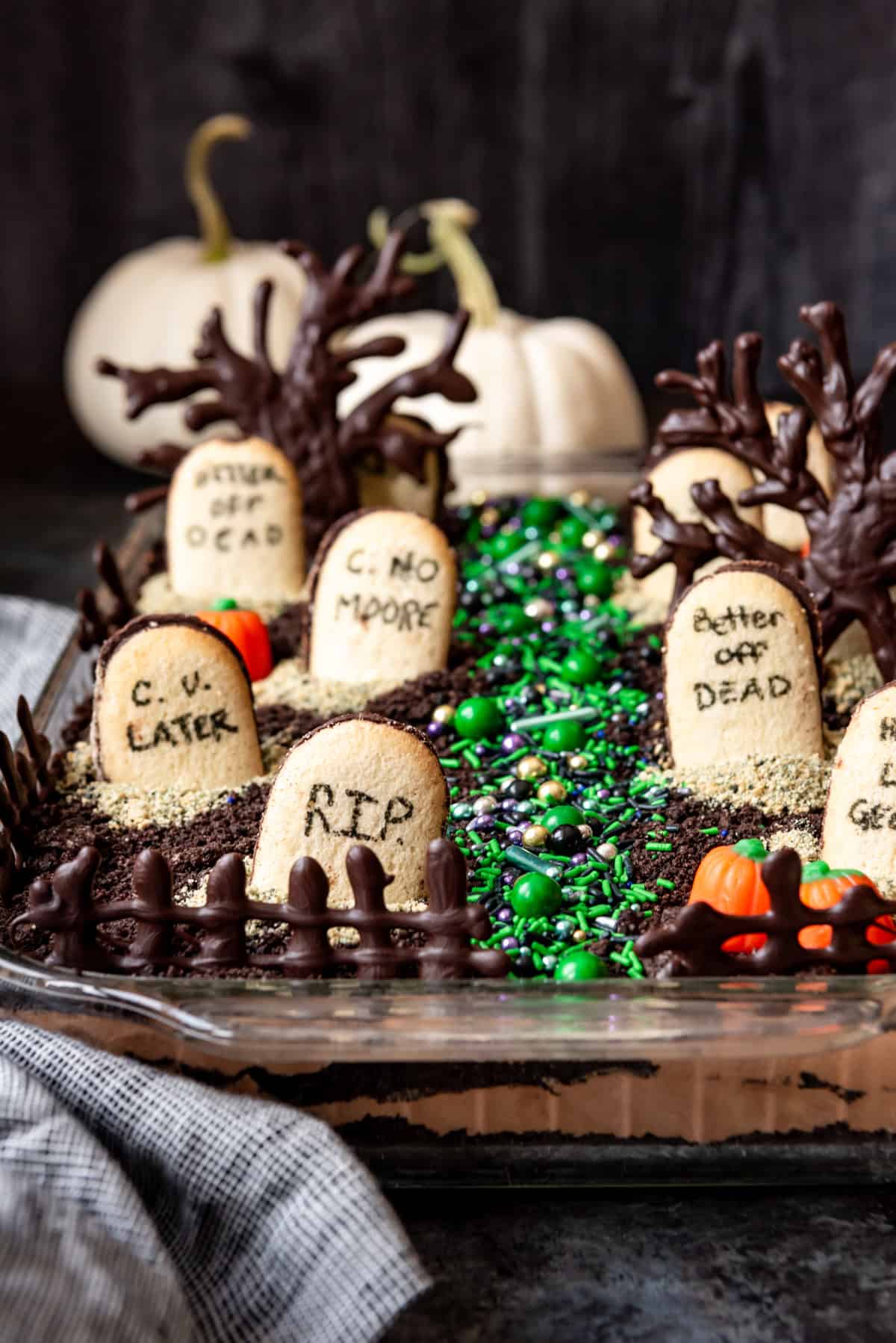 Chocolate dirt pudding with Halloween candy and cookie tombstones on top.