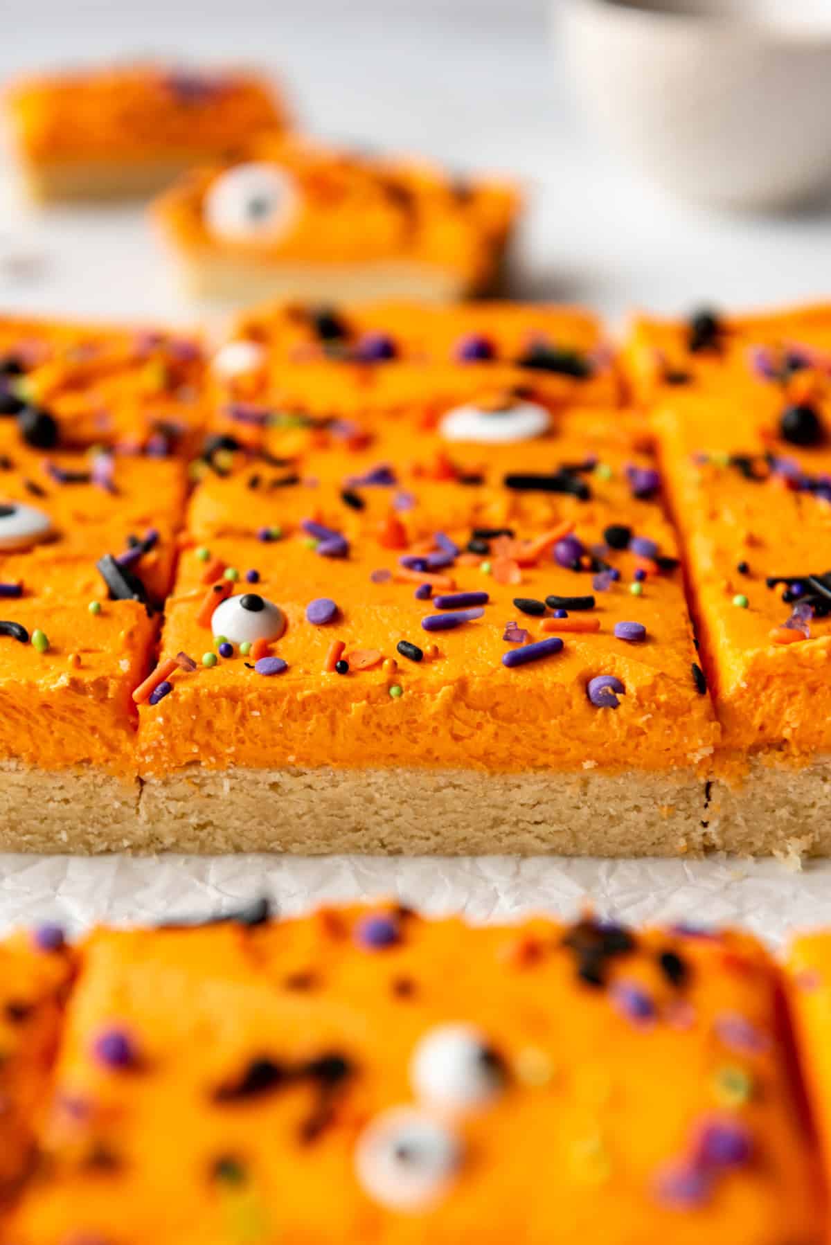 Sugar cookie bars with purple and black sprinkles.