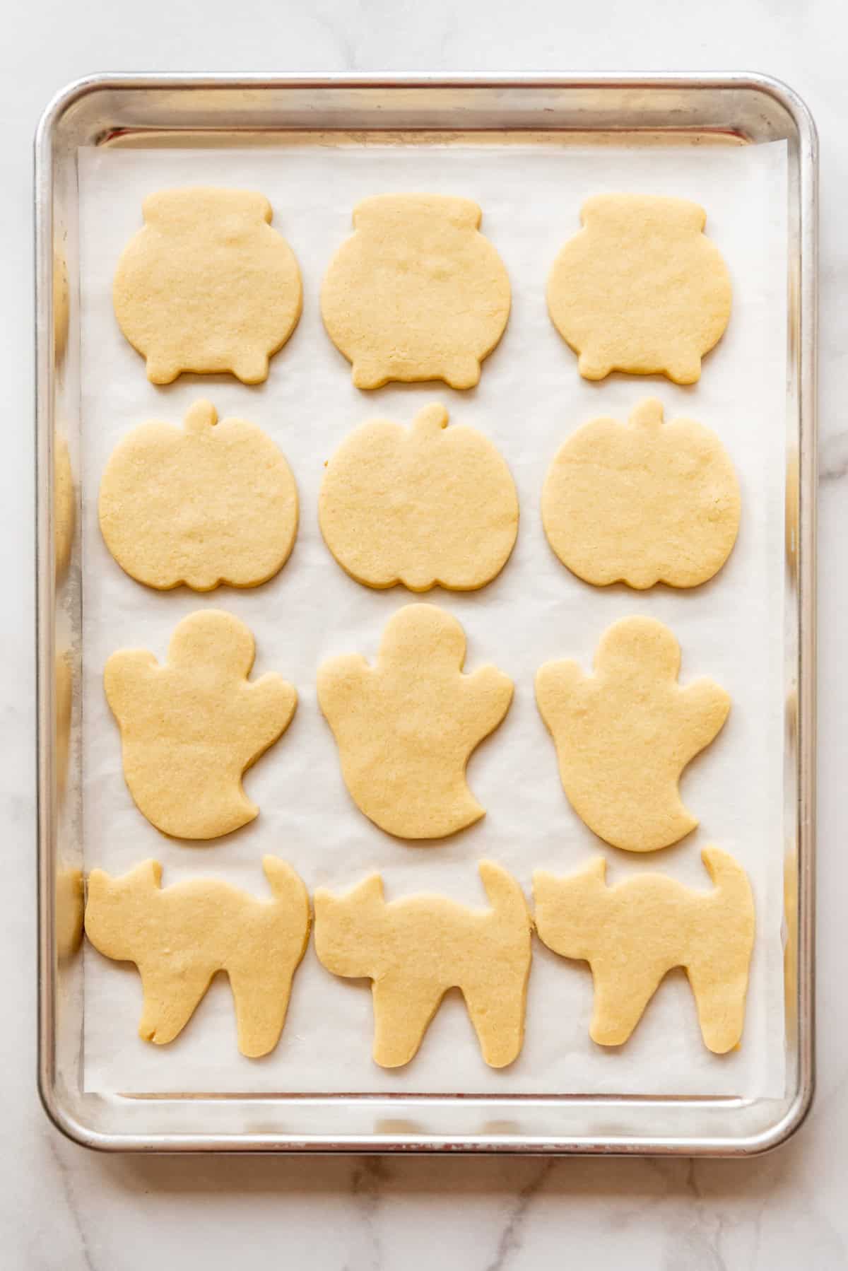 Baked sugar cookies on a baking sheet.