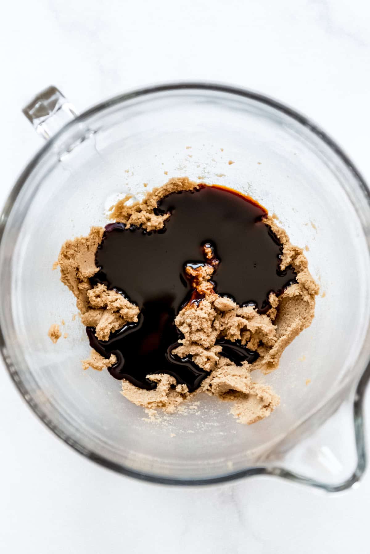 Adding molasses to gingerbread dough.