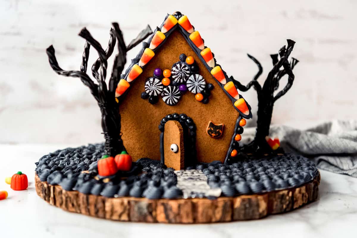 A gingerbread house decorated for Halloween.