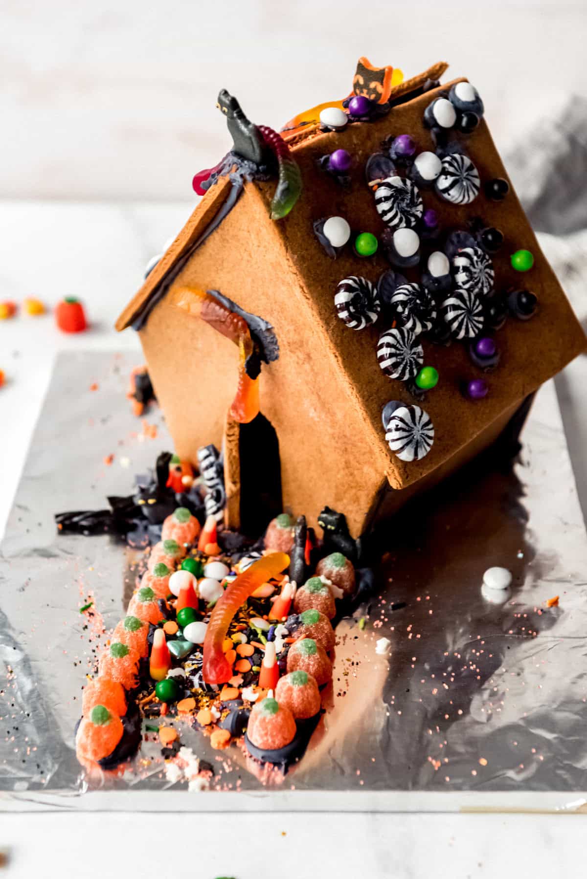 A Halloween gingerbread house decorated by a child.