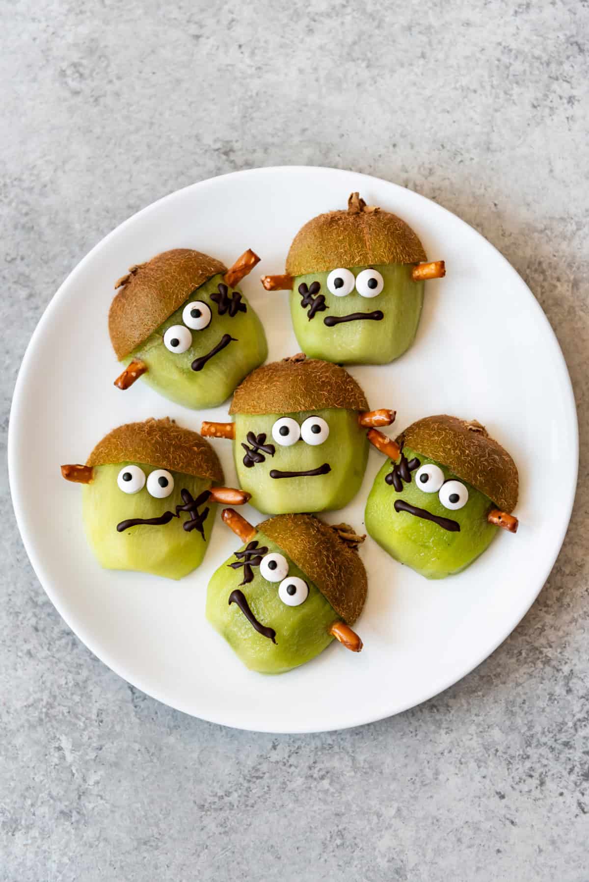 Kiwi halves decorated as Frankenstein.