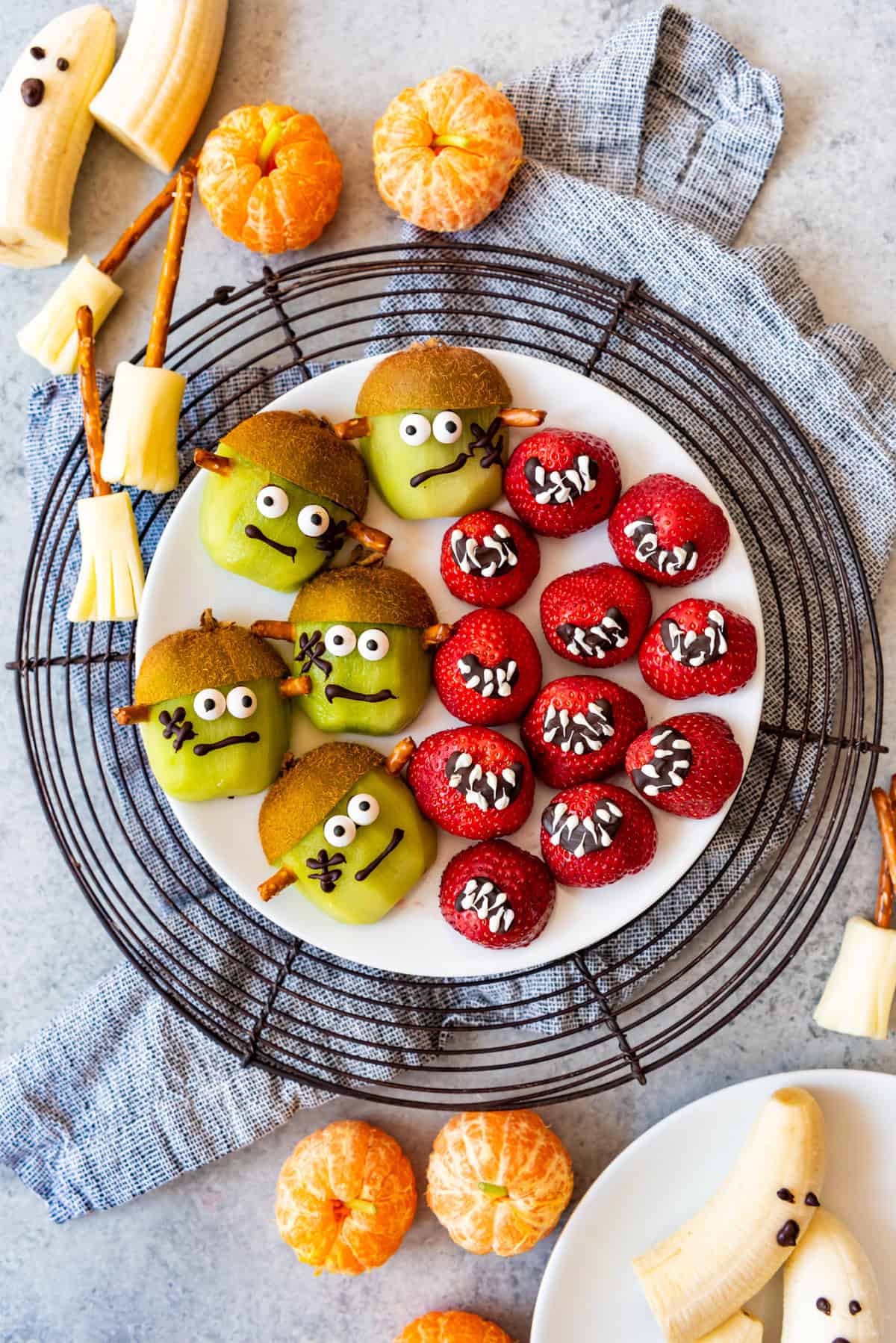 A plate of fruit decorated for Halloween treats.