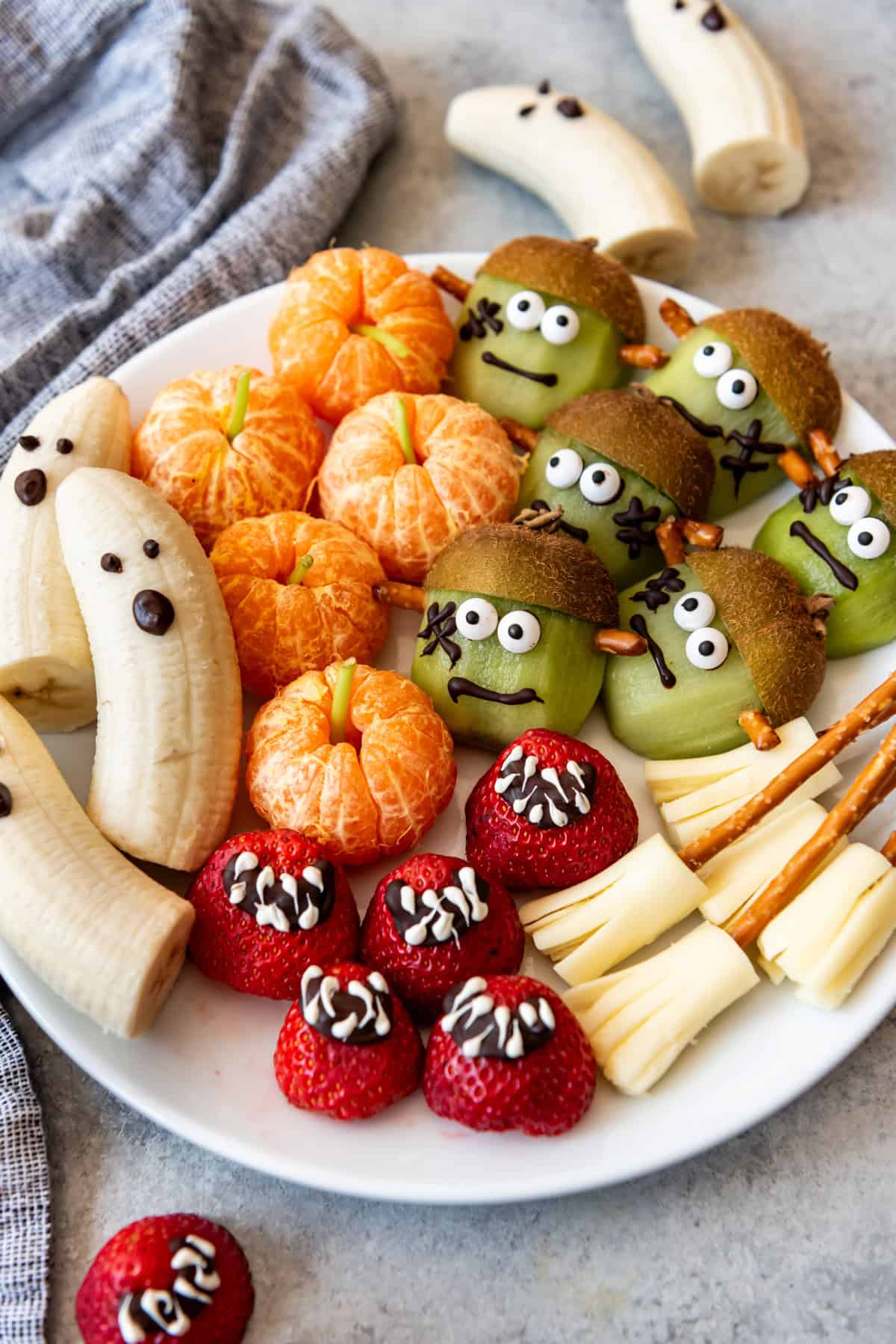 A plate of fruit decorated for healthy Halloween snacks.