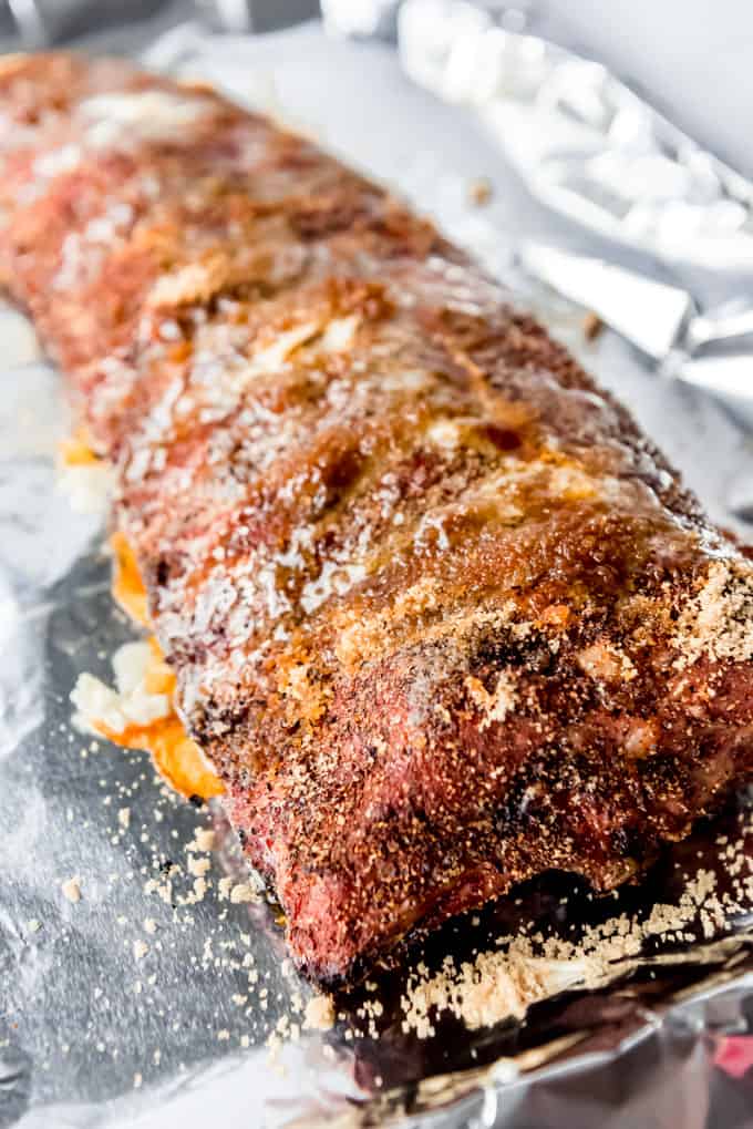 Smoked ribs drizzled with honey, sprinkled with brown sugar, and topped with grated butter.