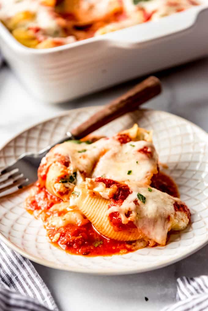 stuffed shells on a plate with a fork
