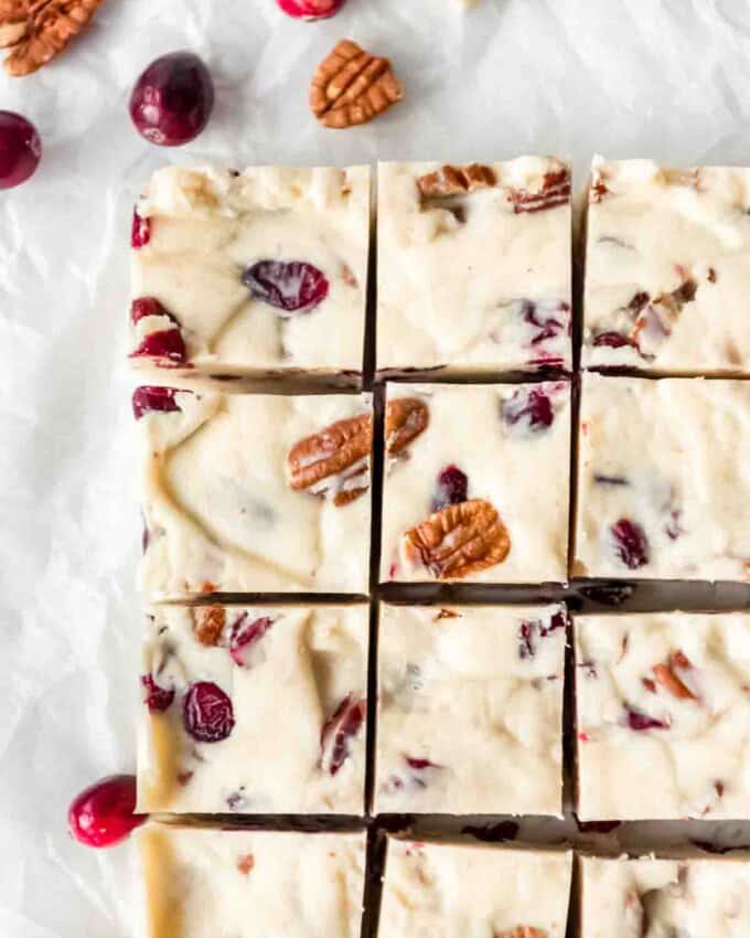 Squares of white chocolate cranberry pecan fudge.