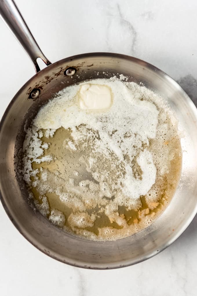Oil and butter melting in a pan.