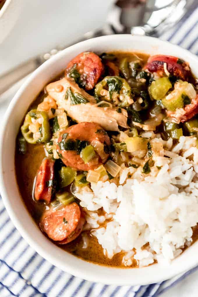 A bowl of chicken and sausage gumbo with rice.