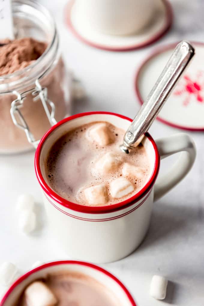 A mug of hot cocoa with marshmallows melting in it.