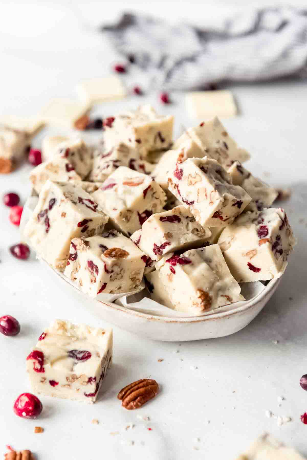 A bowl full of squares of white chocolate fudge.