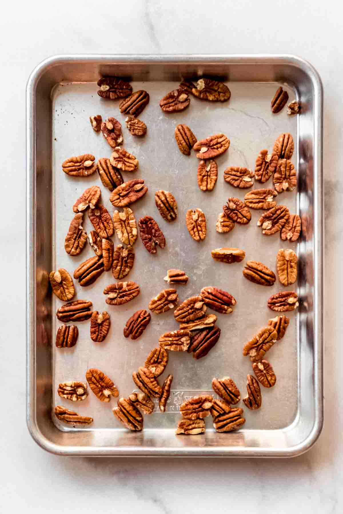 Pecans on a baking sheet.