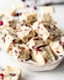 A bowl full of squares of white chocolate fudge.