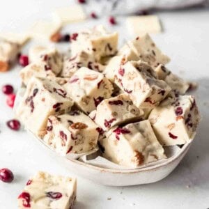 A bowl full of squares of white chocolate fudge.