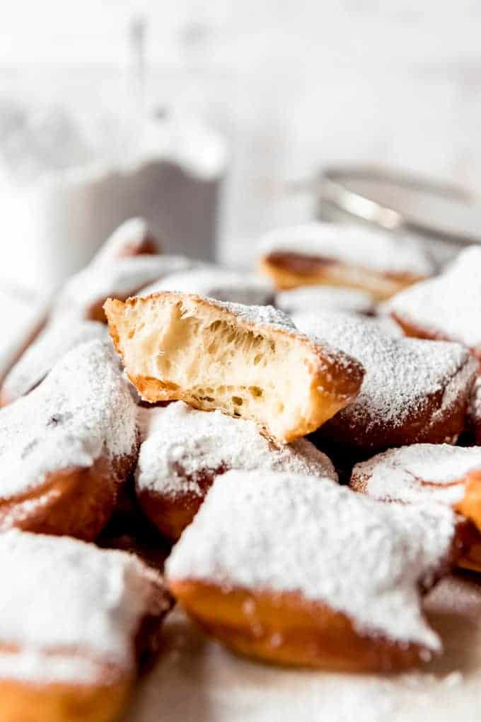 A beignet with a bite taken out of it.