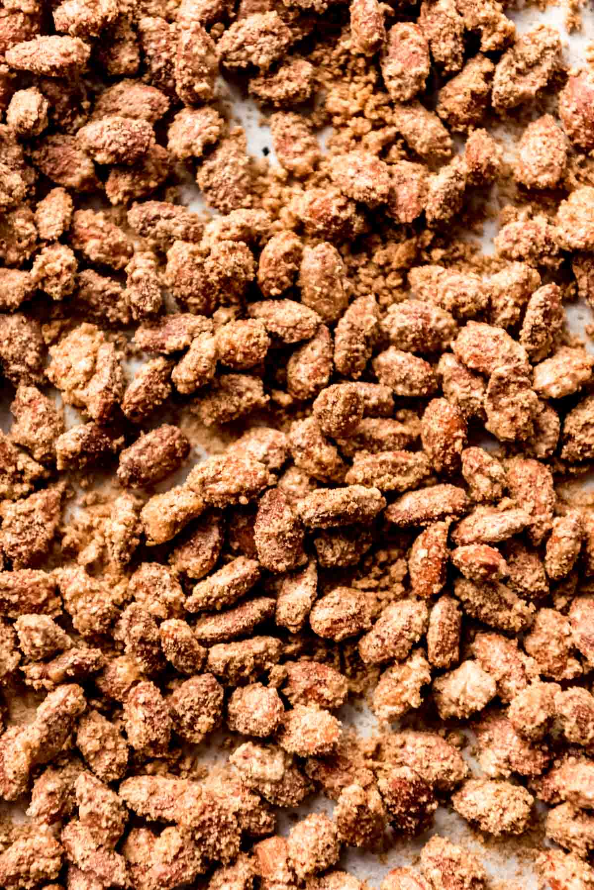 Candied vanilla cinnamon almonds on a baking sheet.