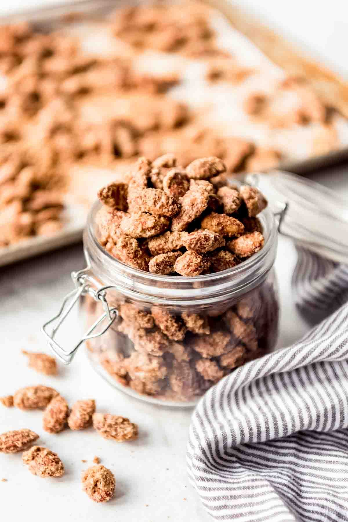 A glass jar filled with candied almonds.