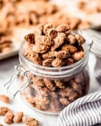 A glass jar filled with candied almonds.