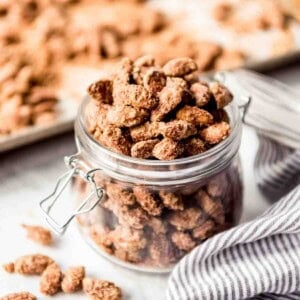 A glass jar filled with candied almonds.