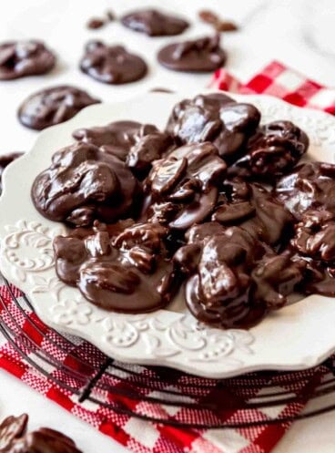 Chocolate pralines on a white plate.