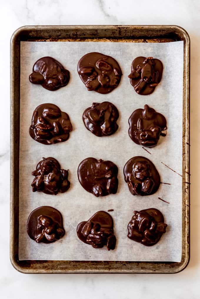 Pralines on a baking sheet lined with parchment paper.
