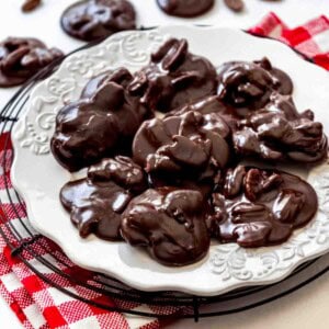 Chocolate pralines on a white plate.