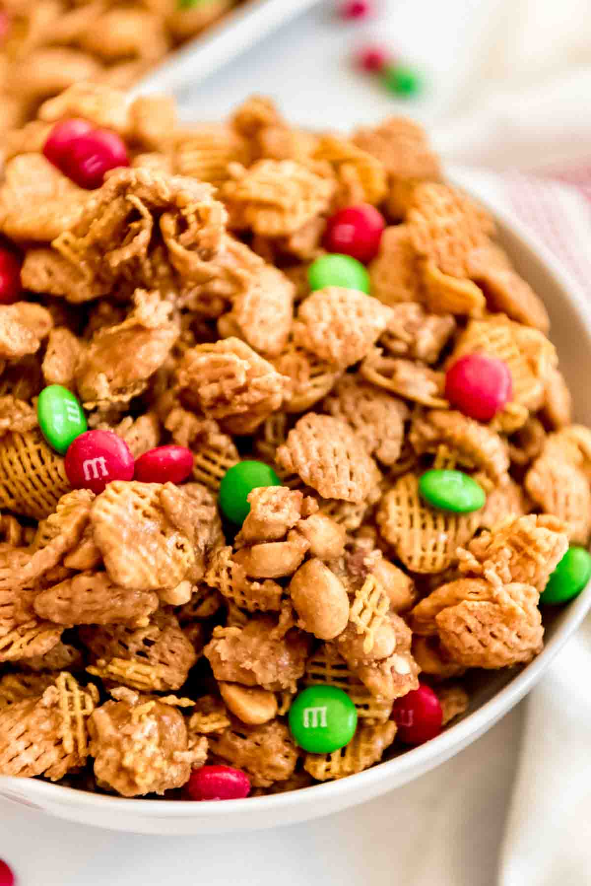 Clusters of crispix cereal and peanuts in a bowl.