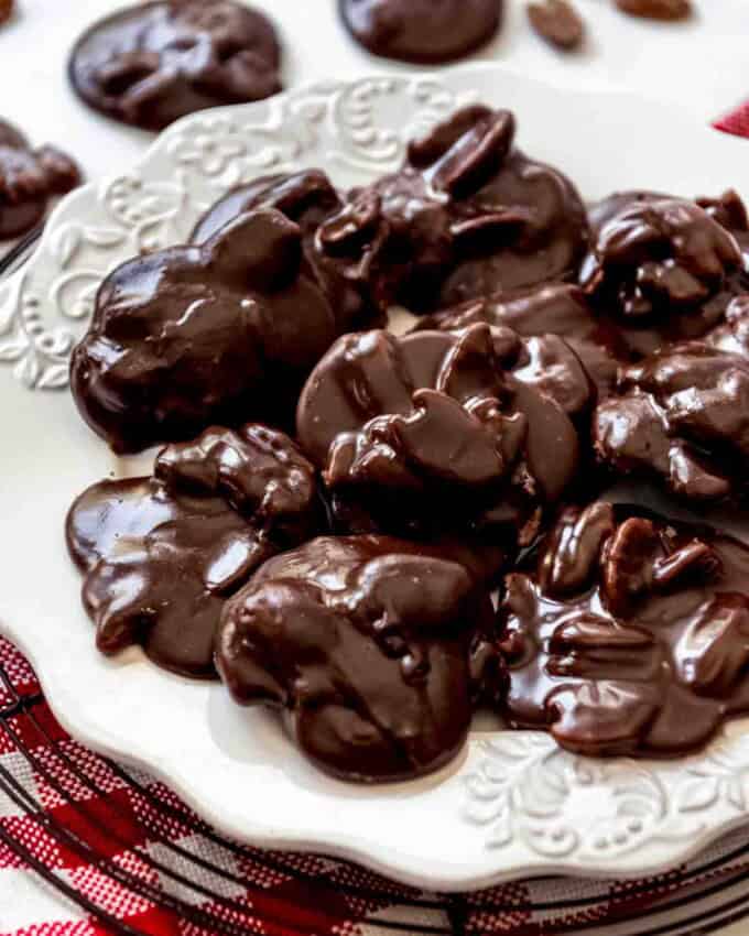 A close image of a plate of chocolate pecan pralines.