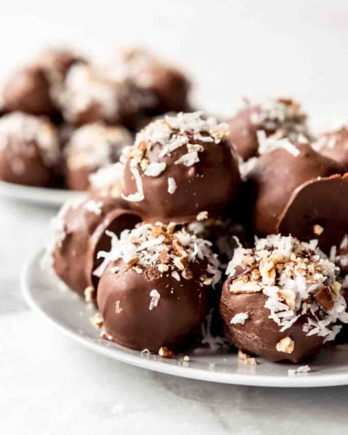 Chocolate cake balls decorated with coconut and pecans.