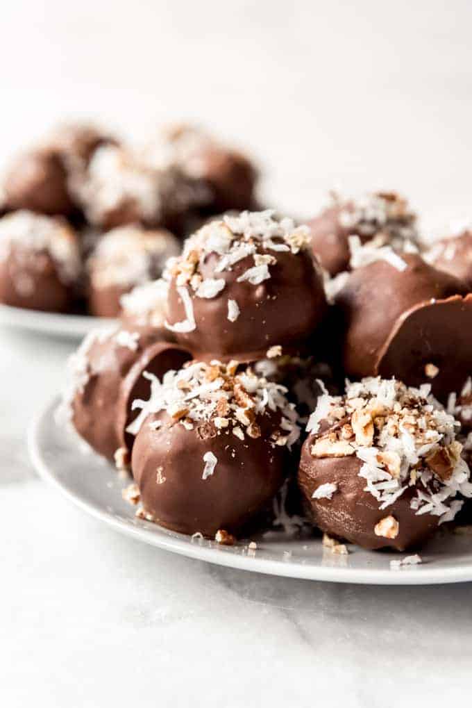 Chocolate cake balls decorated with coconut and pecans.