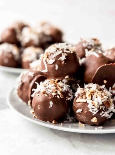 Chocolate cake balls decorated with coconut and pecans.