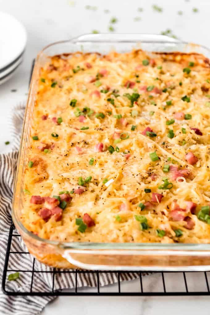 A cheese breakfast casserole topped with green onions.