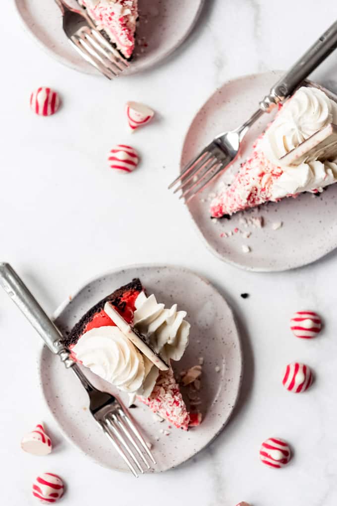 Slices of peppermint cheesecake on dessert plates.